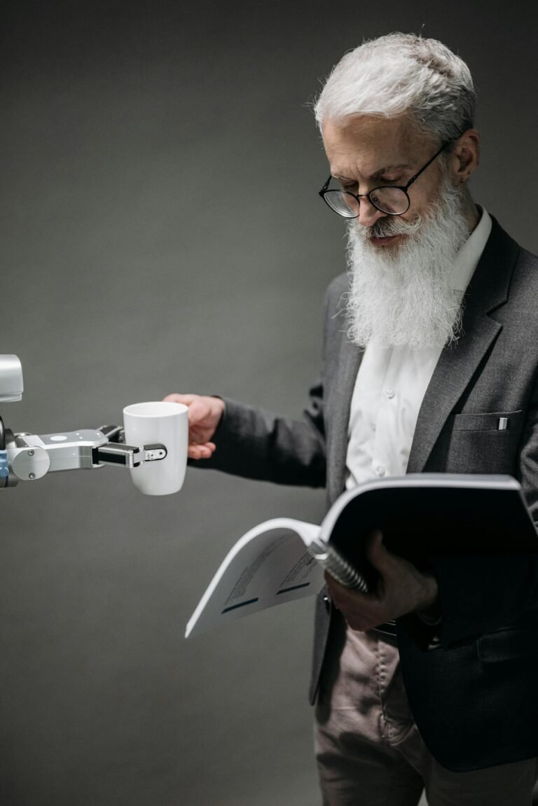 An elderly scientist reads while a robot serves coffee, representing technology's role.